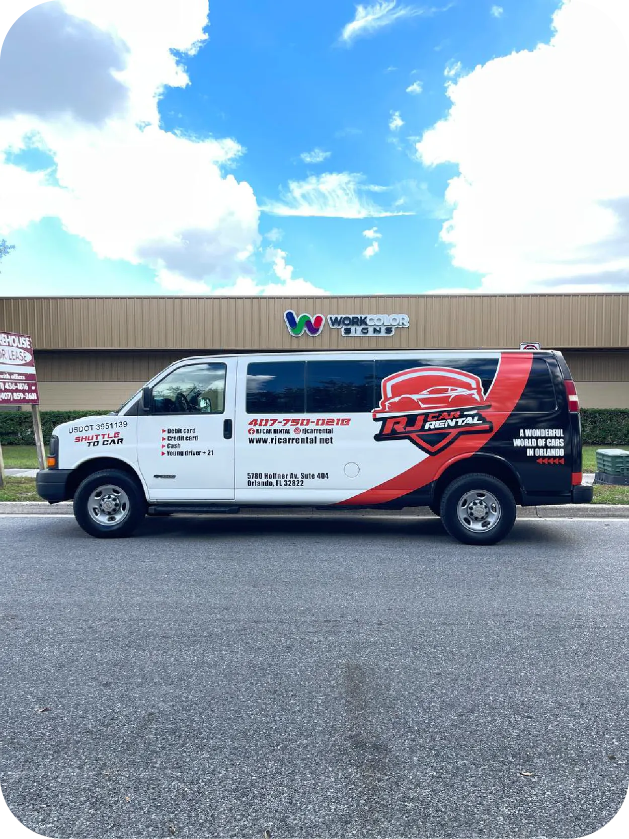 White cargo van with a red and black vehicle wrap