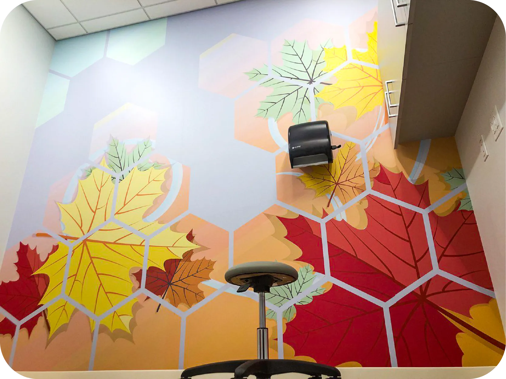 Interior wall wrap with an autumn leaves and hexagon pattern