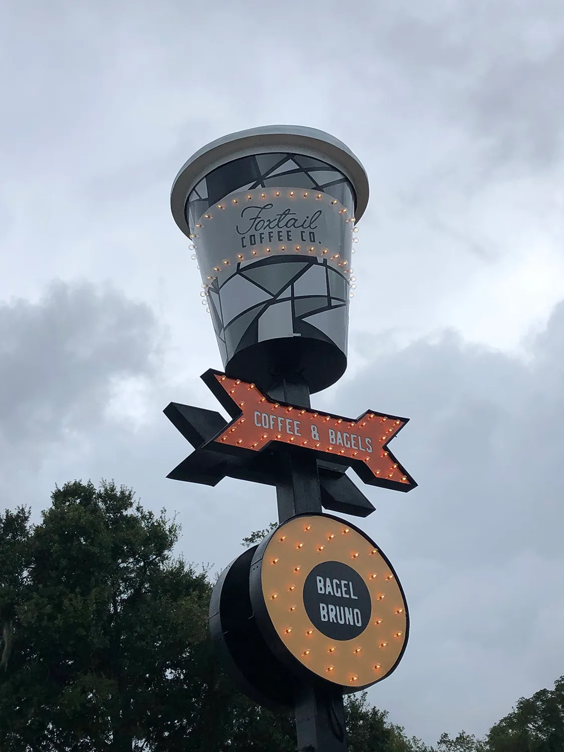 Coffee-cup shaped pole sign for Coffee & Bagels and Bagel Bruno