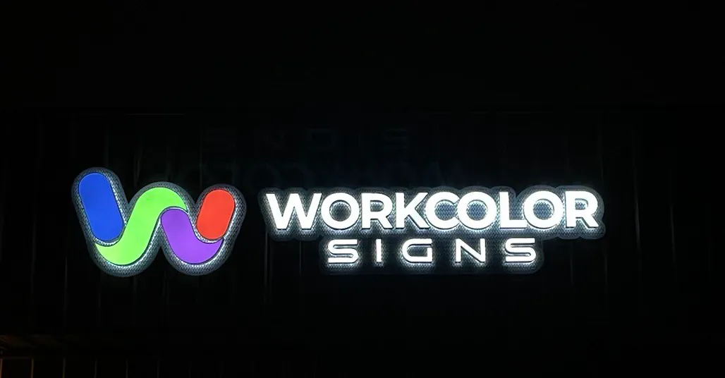 Illuminated Work Color Signs logo sign glowing on a dark wall