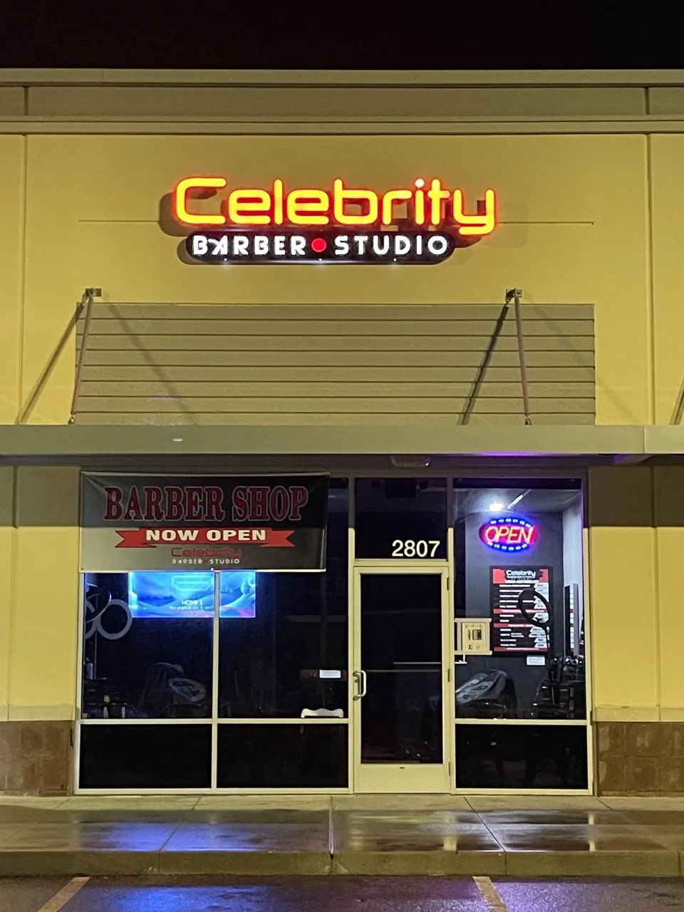 Celebrity Barber Studio illuminated channel letters above a barbershop entrance