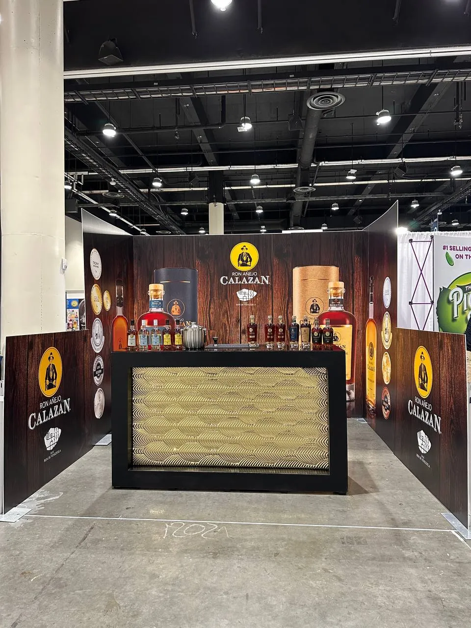 Trade-show booth with printed wall wraps and a bar counter