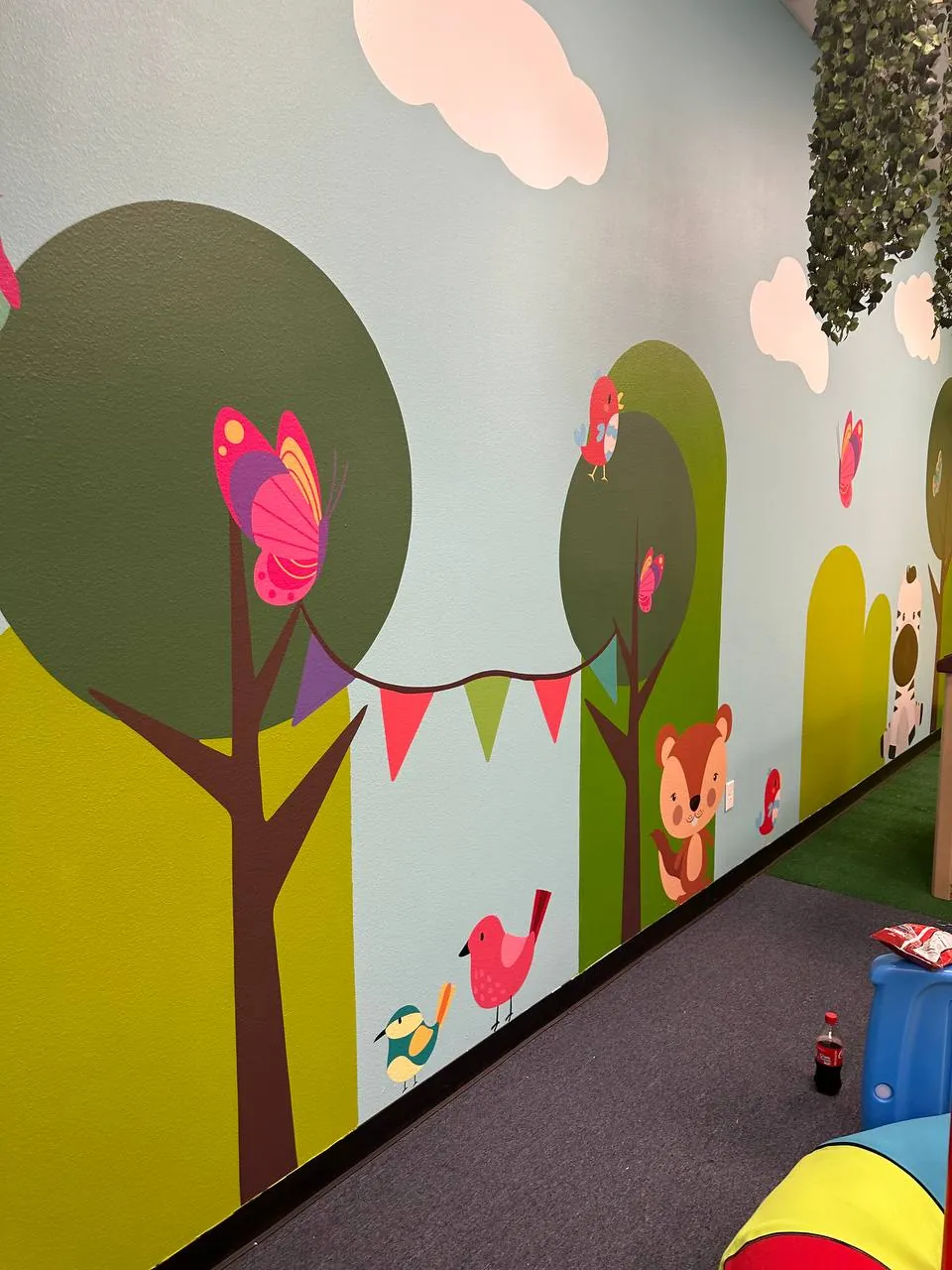 Children's playroom mural with trees, a fox and birds