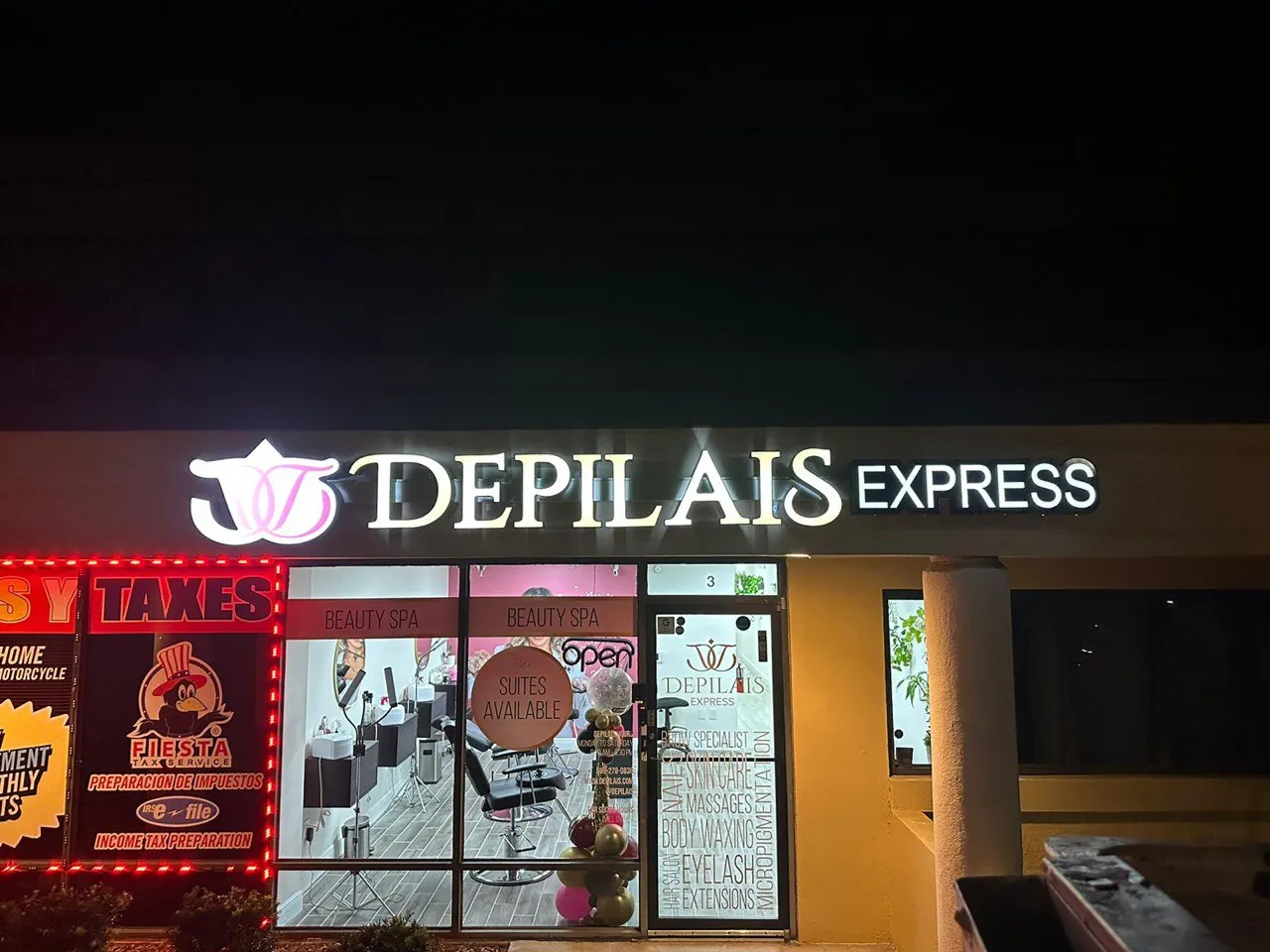 Depilais Express illuminated letters and printed window graphics on a beauty spa at night