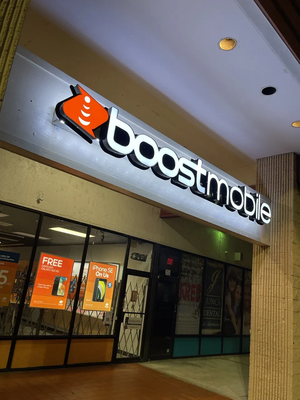 boost mobile illuminated storefront sign over a shop entrance