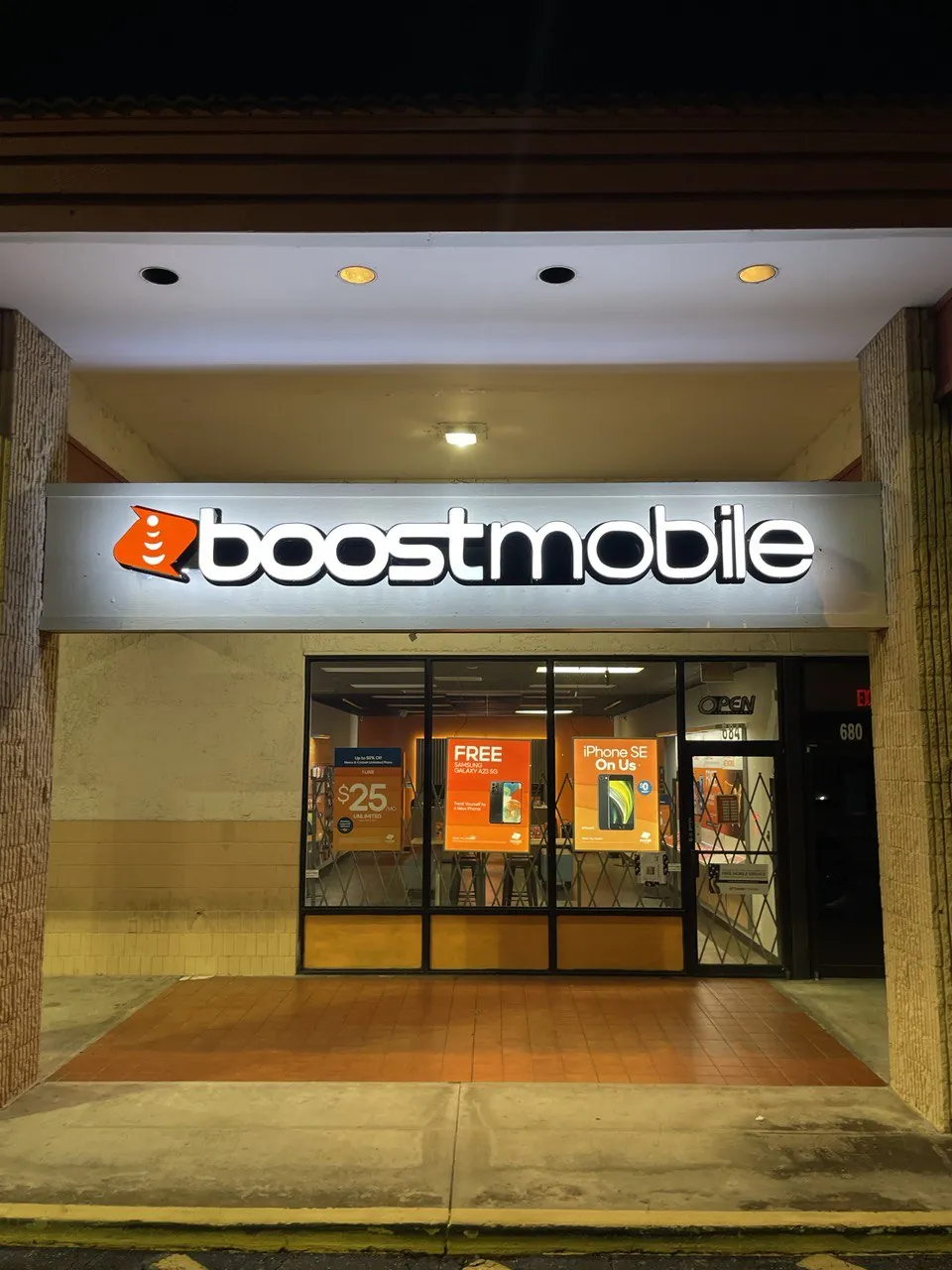 boost mobile sign above a glass shop entrance