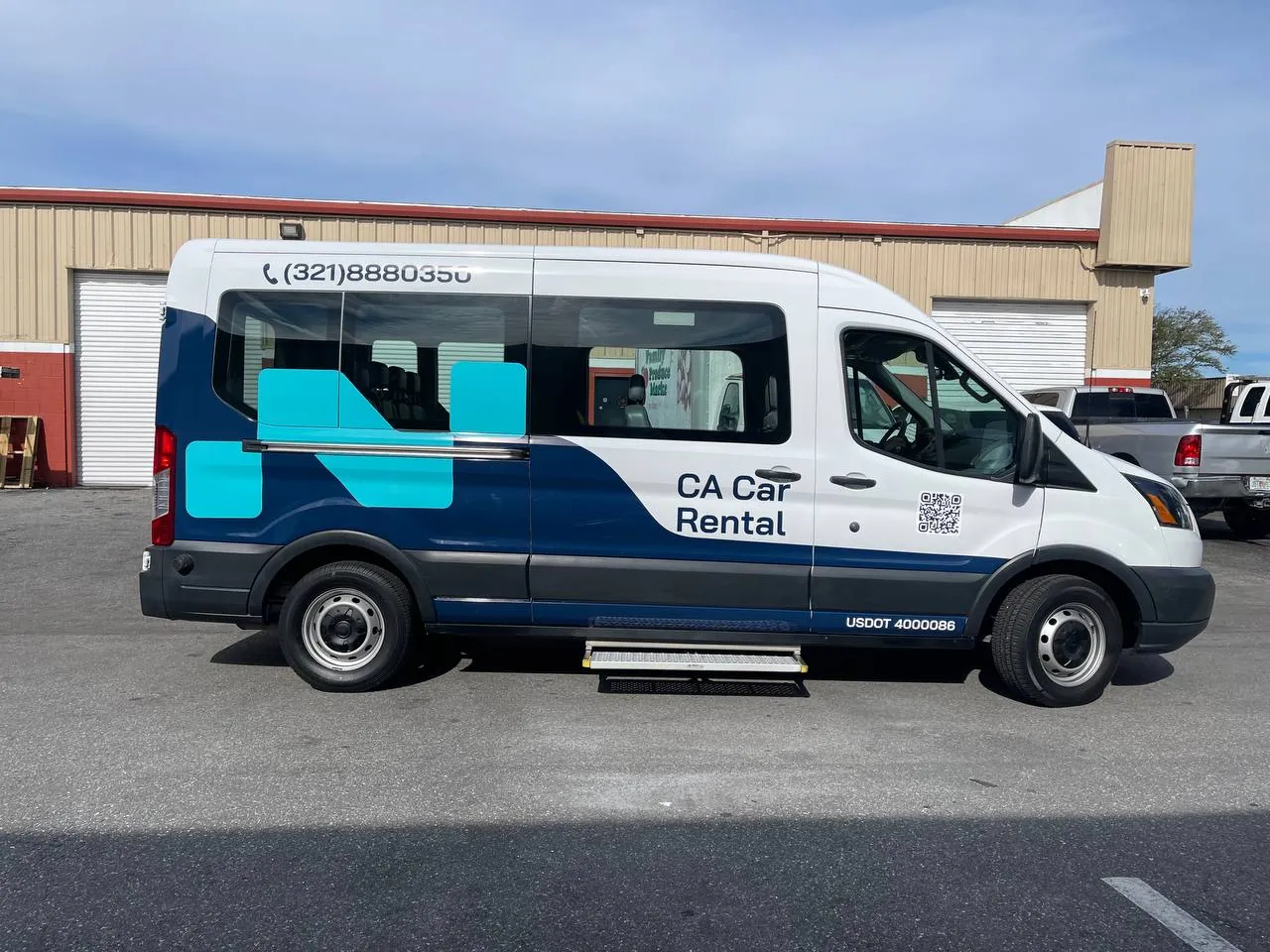 CA Car Rental passenger van with a blue partial wrap