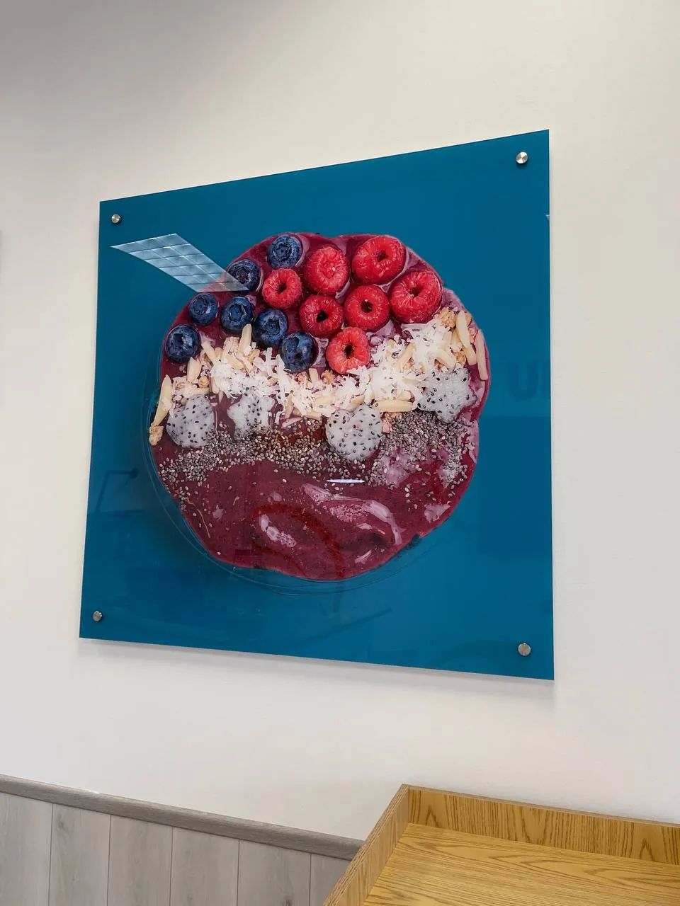 Acrylic wall print of an acai bowl on a teal background