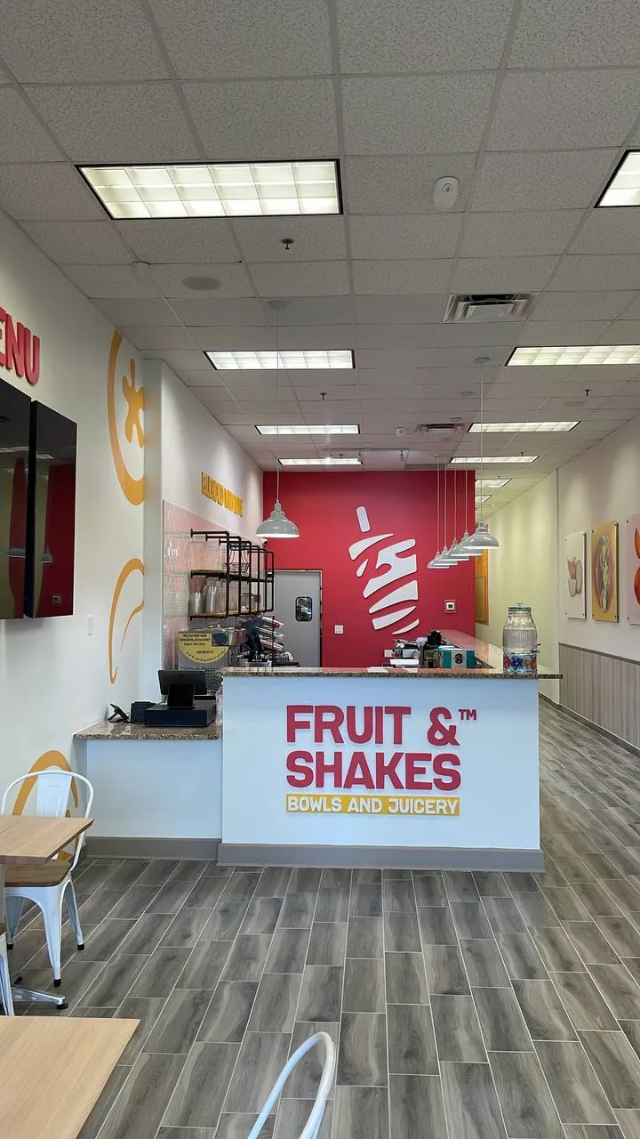 Red Fruit & Shakes wall graphic behind a service counter