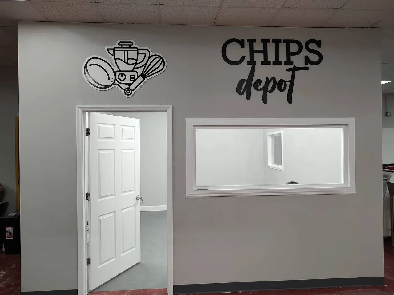 Chips Depot logo wall graphic beside a door and service window