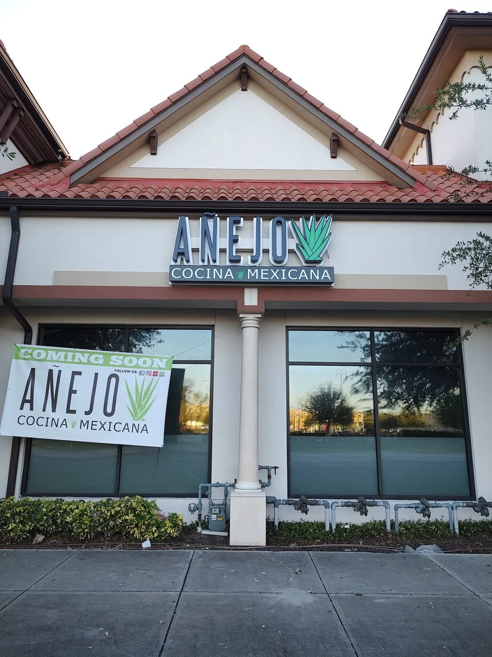 Añejo Cocina Mexicana channel letter sign above the restaurant with a coming-soon banner