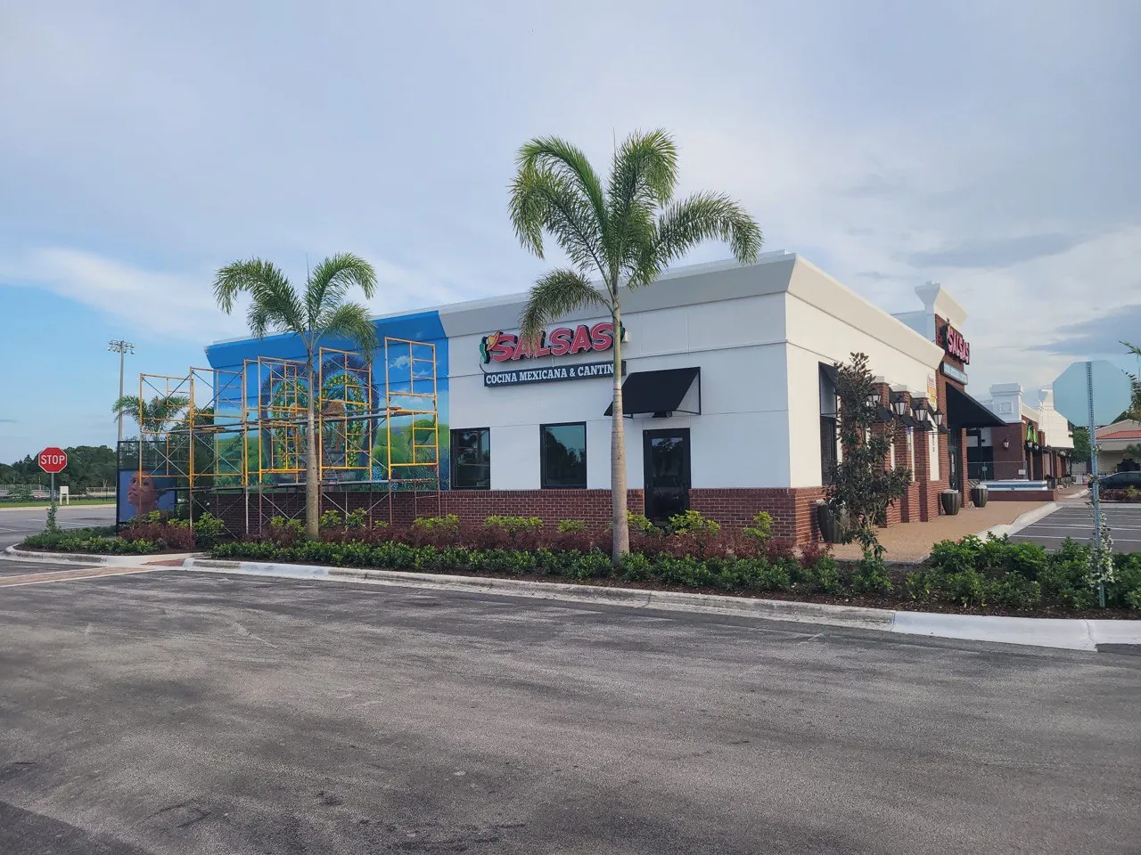 SALSAS restaurant building with its exterior sign and a large mural going up on scaffolding
