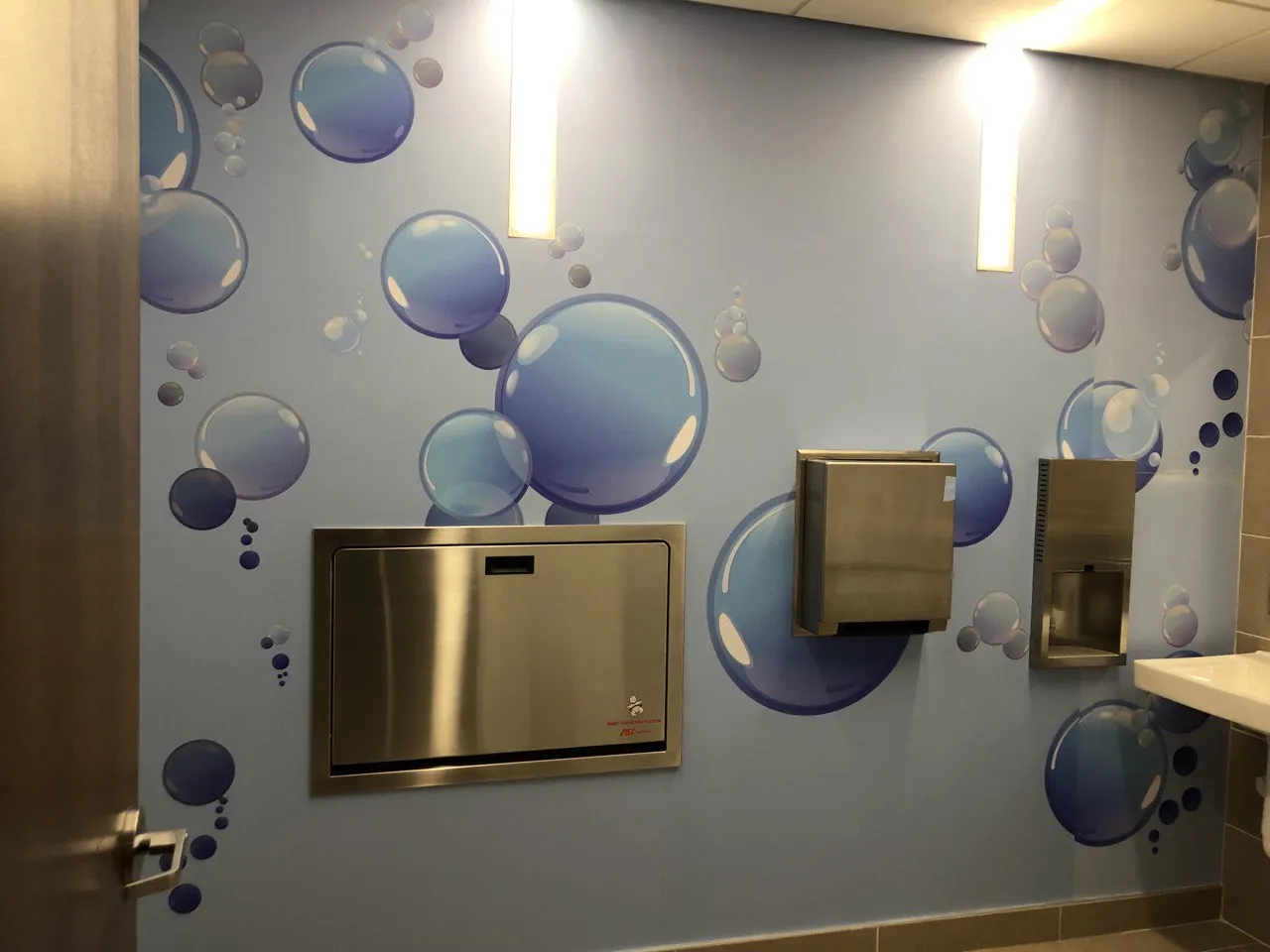 Restroom wall wrap with large blue bubbles