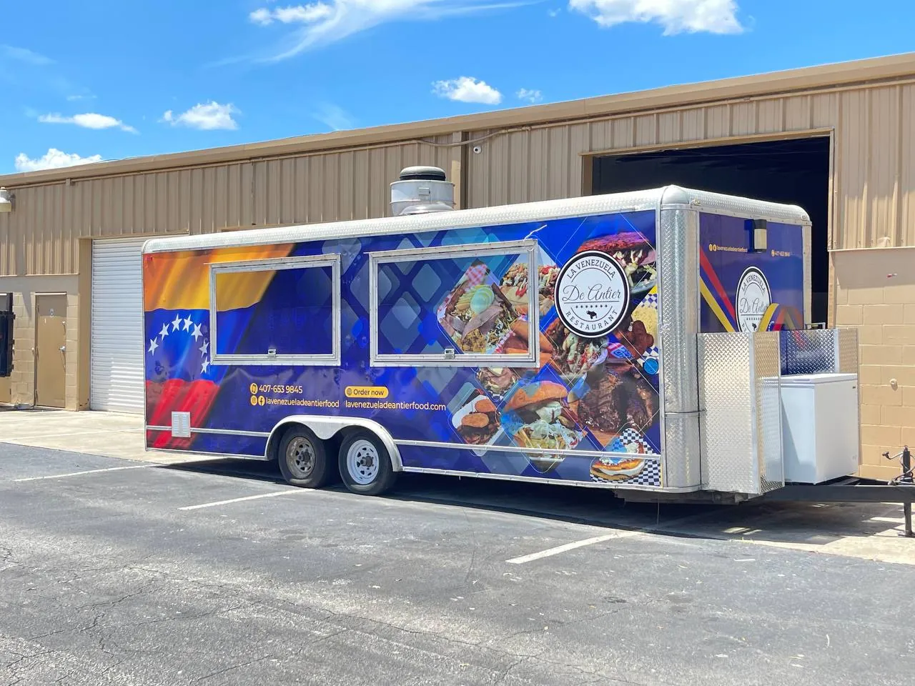 Food trailer with a colorful Venezuelan flag themed wrap