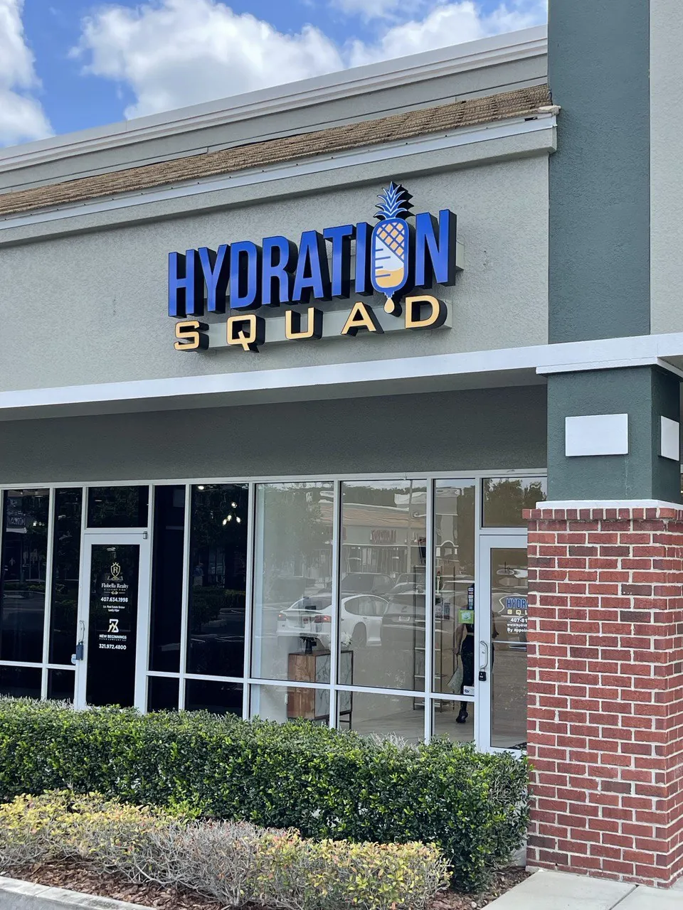 Blue Hydration Squad channel letters on a storefront